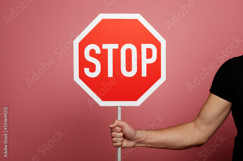 Stop sign. Close-up photo of a stop road sign in a man's hand.