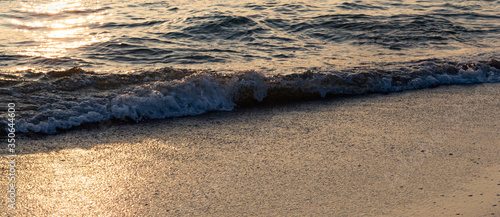 Gentle surf closeup in the sunset