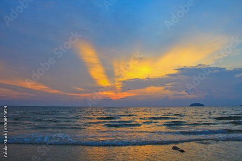 A golden sunset with crashing waves