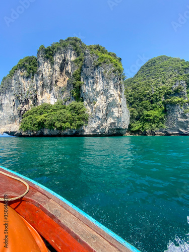Sailing with a longtail private boat to Ko Poda island landscape with big rocks and turquoise water surface, Krabi, Thailand