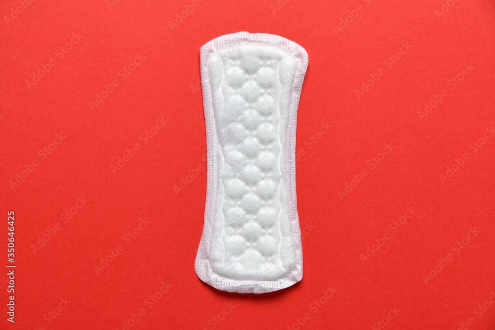 White female pad on a red background. Top view. White female pad on a red background. Top view.