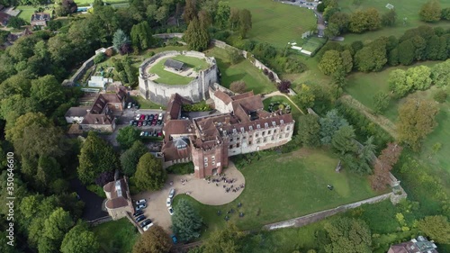 English stately home with guests mingling outside, aerial perspective showing surrounding areas