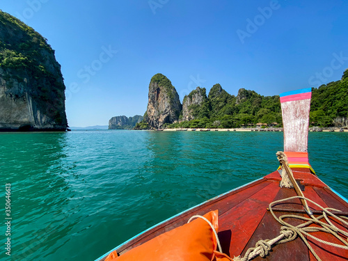 Sailing with a longtail private boat to Railay Beach Bay, one of the most famous luxurious beach of Krabi, Thailand.