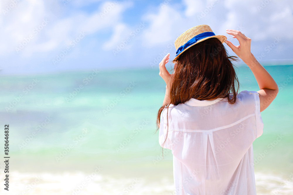 Woman laying on the beach enjoying summer holidays looking at the sea Woman laying on the beach enjoying summer holidays looking at the sea