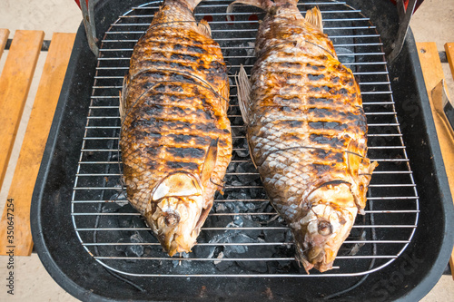 Fish on the grill with vertical orientation. Roast bocachico