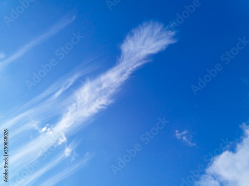 A deep blue sky with clouds like a sword hilt