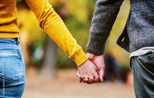 Romantic couple holding hands, close up photo. Love, dating, romance