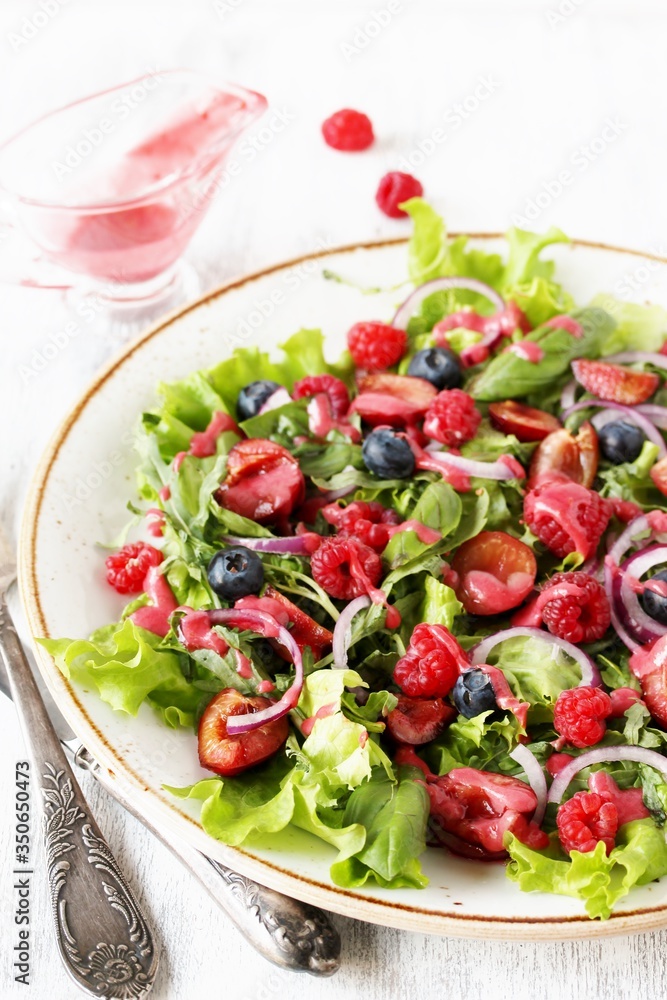 Salad with berries-raspberry, blueberry, sweet cherry. Dressed with raspberry vinaigrette. Soft focus. copy space Salad with berries-raspberry, blueberry, sweet cherry. Dressed with raspberry vinaigrette. Soft focus. copy space