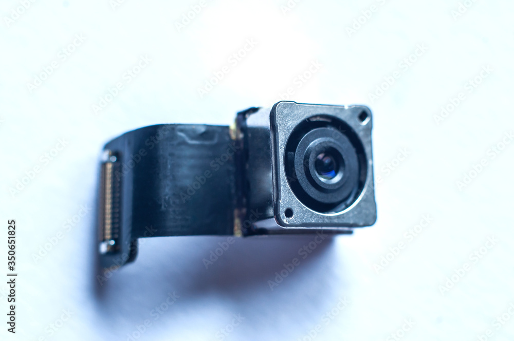Small camera for spying on people with a connection cable, close-up, macro shot.
