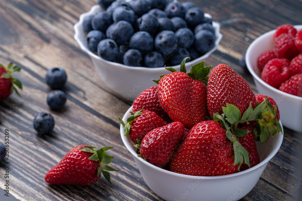 Berries, summer fruits on a wooden table. Healthy lifestyle concept. Selective focus Berries, summer fruits on a wooden table. Healthy lifestyle concept. Selective focus