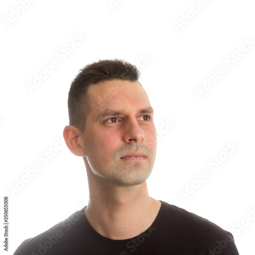 Handsome smiling young man looking up over white background