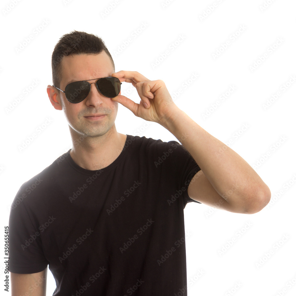 Naklejka premium Headshot of a young man wearing aviator sunglasses, isolated on white