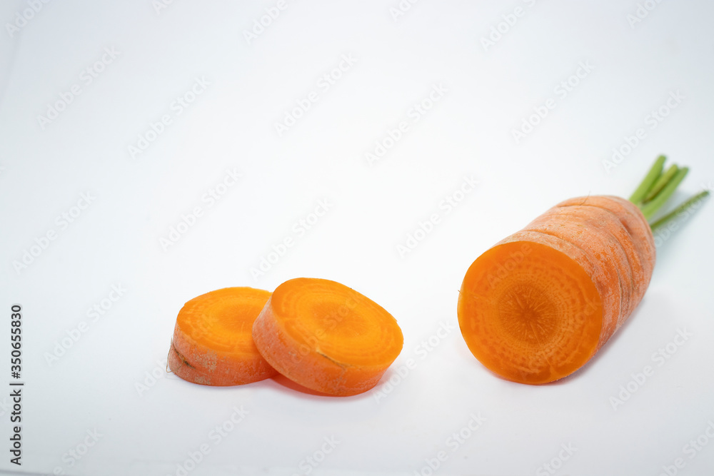 Close up view of a single sliced carrot isolated on a white background. Space for copy.
