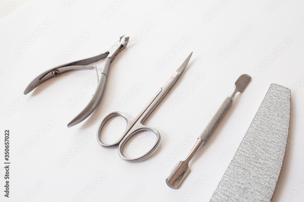 set of tools for manicure on a white background close-up. top view, text space. set of tools for manicure on a white background close-up. top view, text space.
