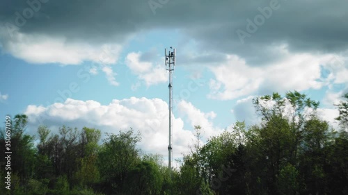 Clouds float past the cell tower. Tower against the sky. Timelapse nature and technology
