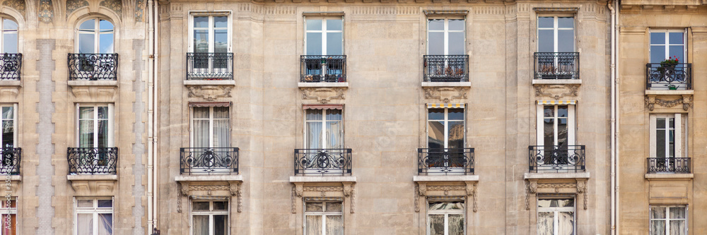 Paris House with chimney and windows. Haussmann epoque, beautiful balconies, traditional french building. Banner