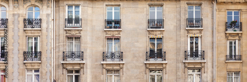 Paris House with chimney and windows. Haussmann epoque, beautiful balconies, traditional french building. Banner