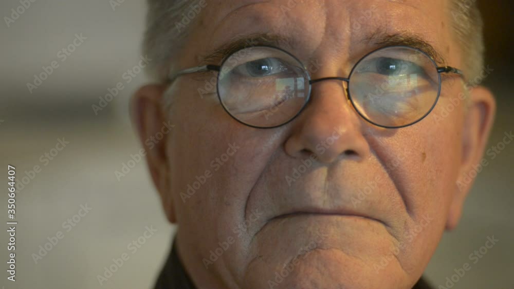 Face of senior man with eyeglasses indoors Face of senior man with eyeglasses indoors