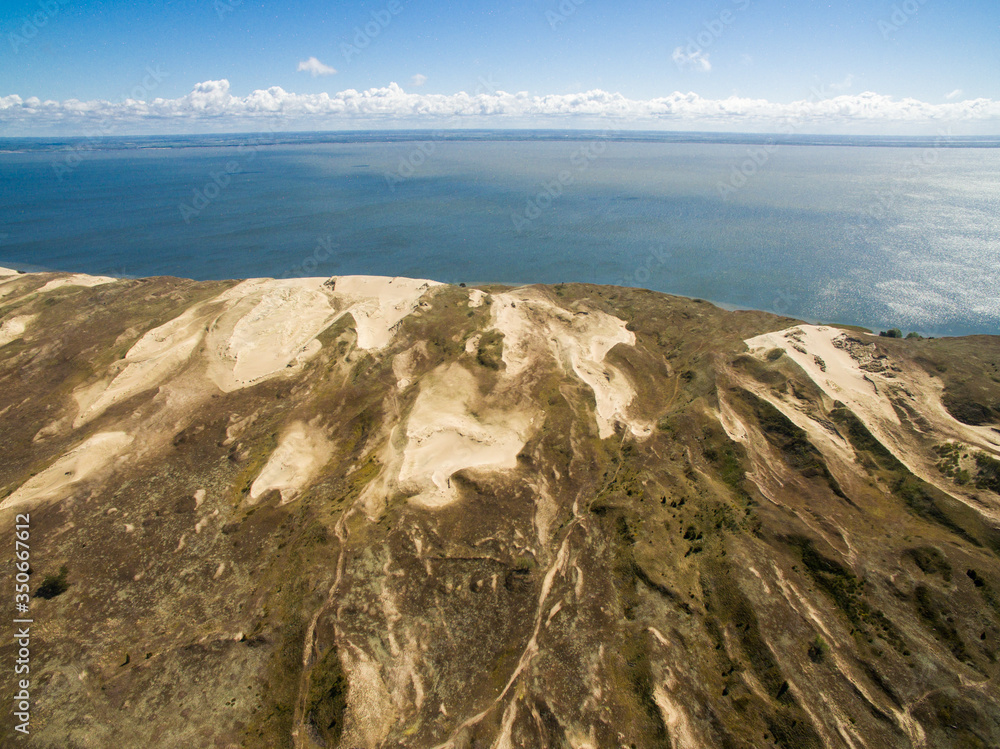 Aerial view with dunes, forest and sea in Curonian spit on a sunny day photographed with a drone. The Curonian Spit lagoon. Gray Dunes, Dead Dunes. Aerial view with dunes, forest and sea in Curonian spit on a sunny day photographed with a drone. The Curonian Spit lagoon. Gray Dunes, Dead Dunes.