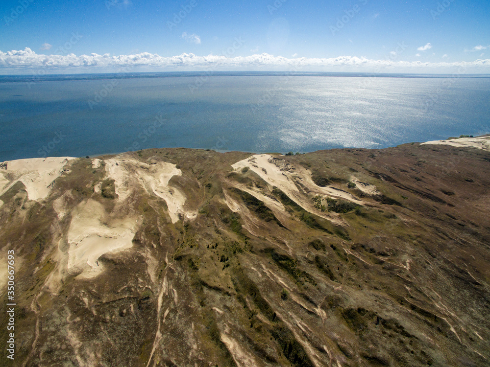 Aerial view with dunes, forest and sea in Curonian spit on a sunny day photographed with a drone. The Curonian Spit lagoon. Gray Dunes, Dead Dunes. Aerial view with dunes, forest and sea in Curonian spit on a sunny day photographed with a drone. The Curonian Spit lagoon. Gray Dunes, Dead Dunes.
