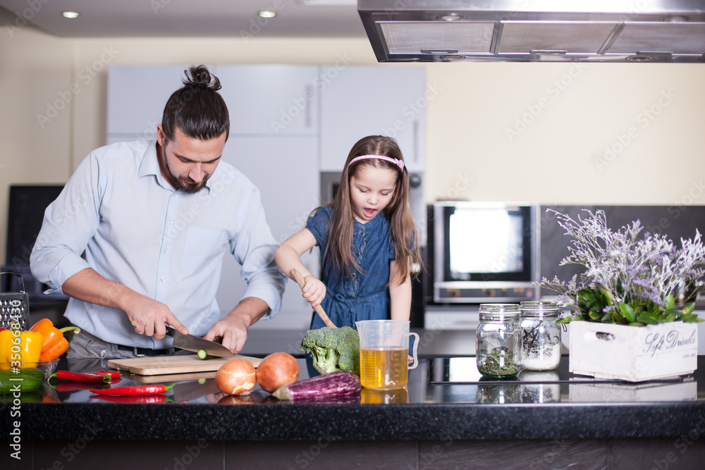 Father and daughter cooking together. Family concept. Father and daughter cooking together. Family concept.