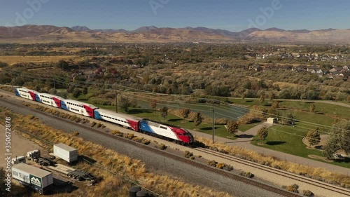 Aerial of train going through suburban town in western United States photo
