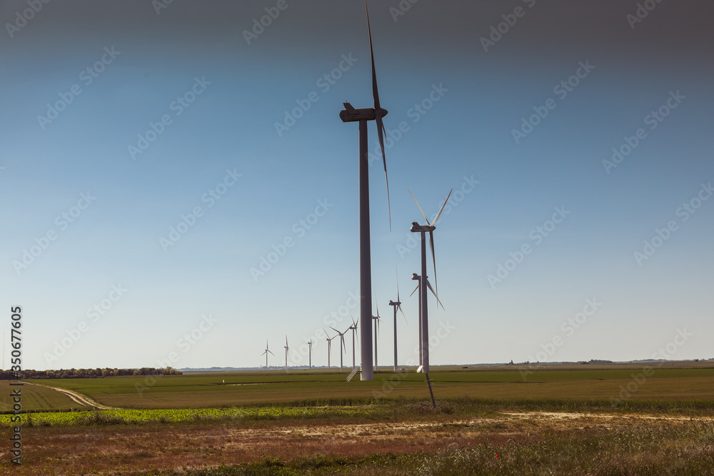 Obraz premium Windmill for electric power production, France. Blue sky