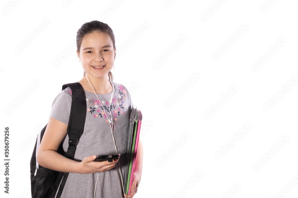 schoolgirl laughs with a smartphone in her hands and looks forward schoolgirl laughs with a smartphone in her hands and looks forward