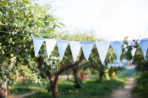Canvas-taulu Flags birthday decorations hanging on tree branch in garden