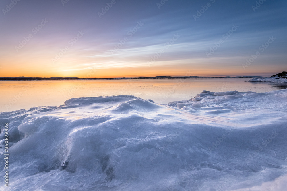 Glazed coast. The shore of the White Sea in Kandalaksha Bay is covered with glaze-like ice after low tide