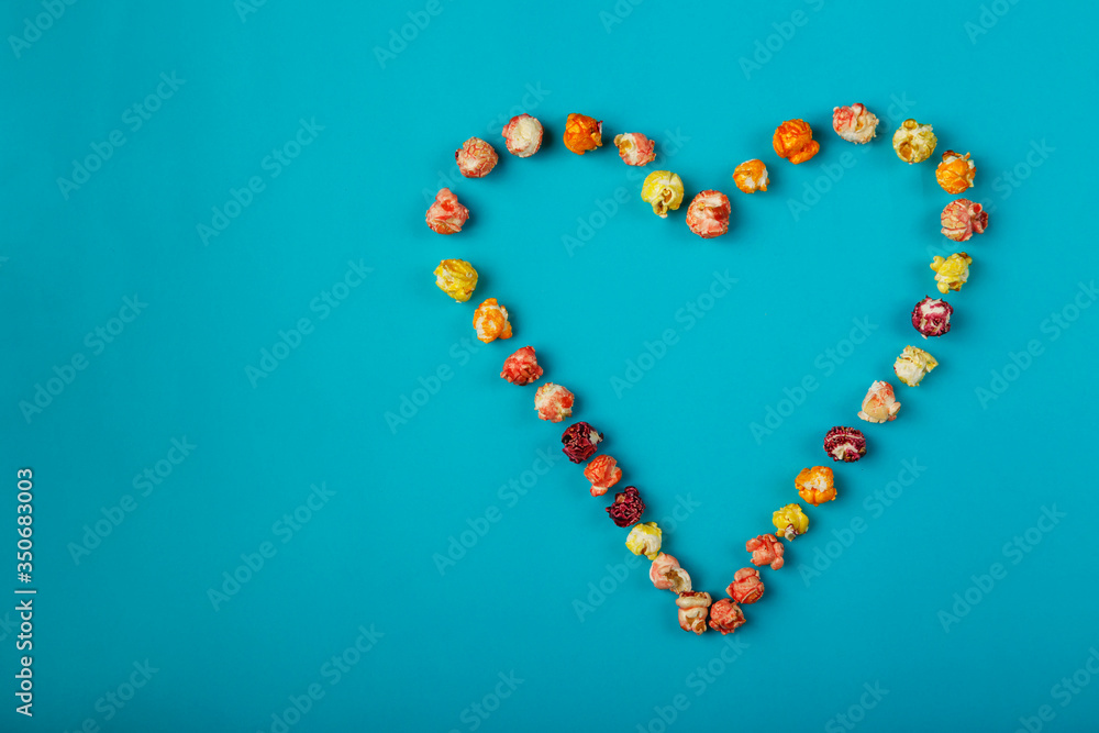Heart laid out of corn kernels on a blue background. Heart laid out of corn kernels on a blue background.