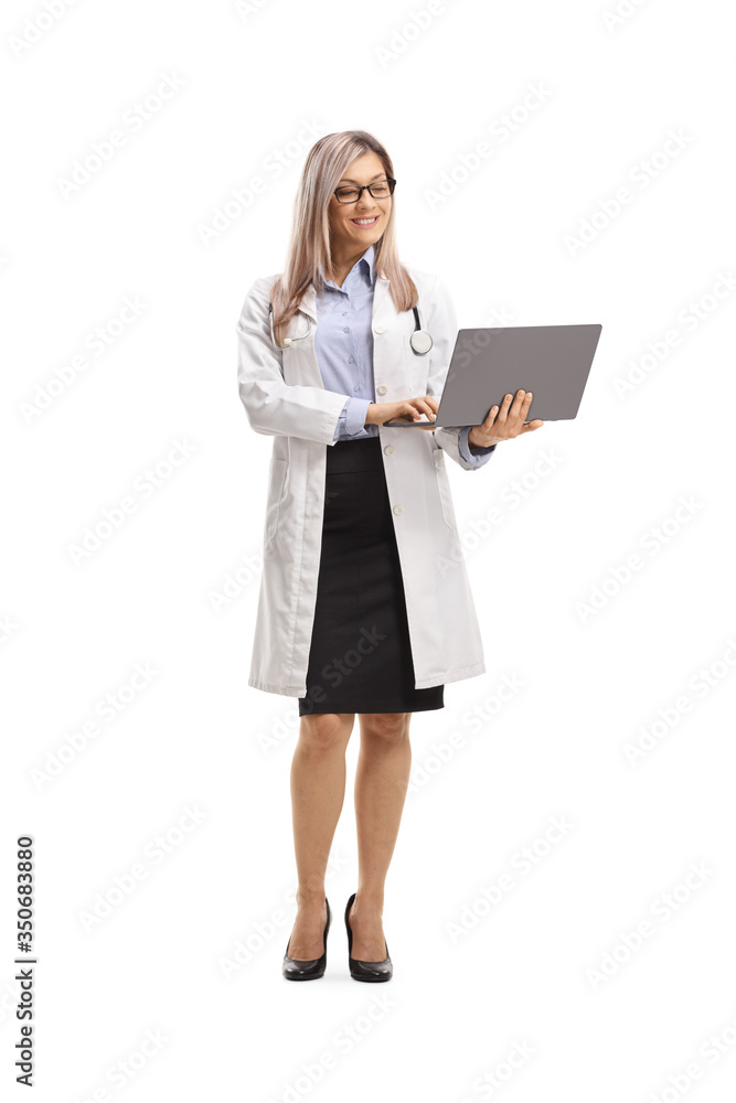 Female doctor standing and using a laptop computer Female doctor standing and using a laptop computer