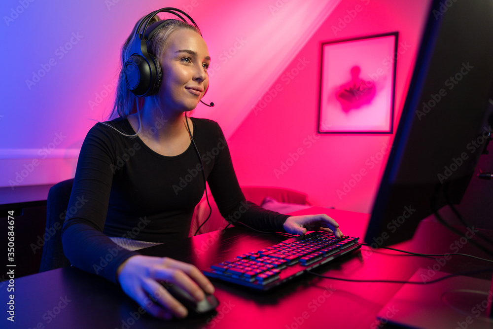 Happy and Beautiful Blonde Gamer Girl Playing Online Video Game on Her  Personal Computer Stock Photo by kjekol