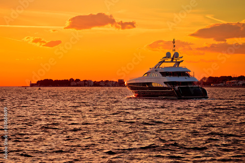 Luxury yacht on open sea at golden sunset © xbrchx