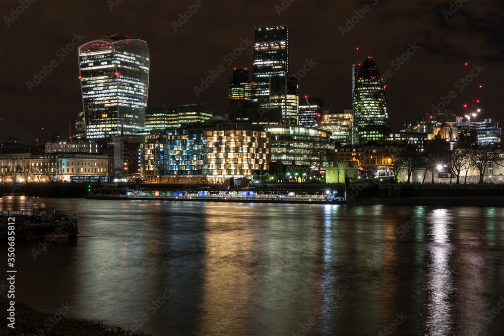 Night photo of London with illuminated skyscrapers 
