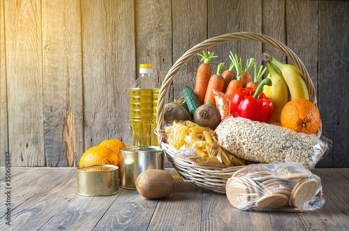 Valokuva Food donation background with food assortment on the wooden table
