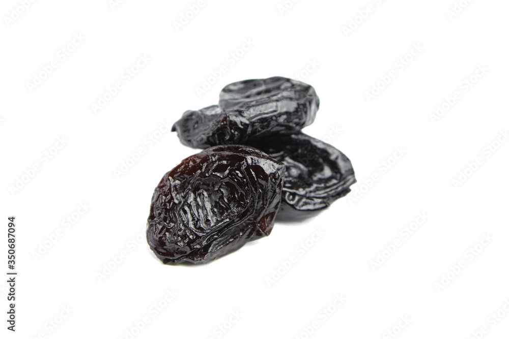 Prunes, dry plums isolated on white background. Heap of dried fruits Prunes, dry plums isolated on white background. Heap of dried fruits