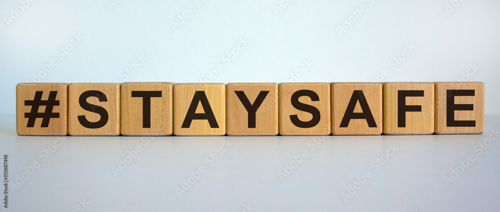 Wooden cubes form the words 'staysafe'. Beautiful white background. Wooden cubes form the words 'staysafe'. Beautiful white background.
