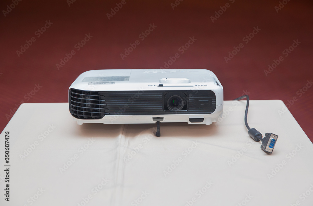 LCD Projector technology video presentation and home Entertainment object . mini led projector on wood table in a room projector home theater idea and concept . Close up projector in conference room . LCD Projector technology video presentation and home Entertainment object . mini led projector on wood table in a room projector home theater idea and concept . Close up projector in conference room .