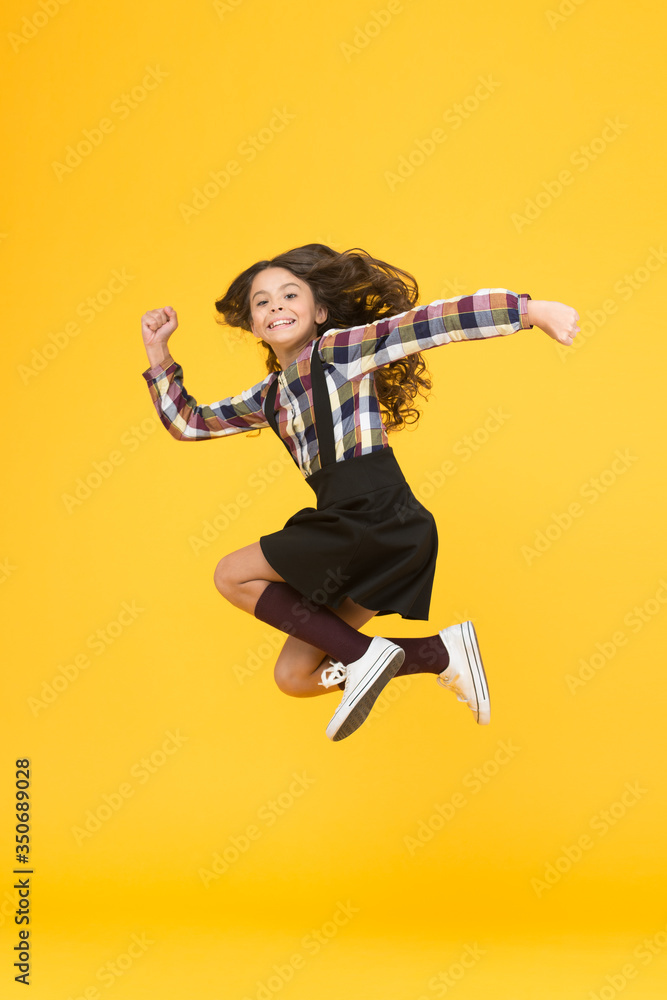 Free style. Happy schoolchild in midair yellow background. Free from school. Summer holidays. Free time. All good things are wild and free Free style. Happy schoolchild in midair yellow background. Free from school. Summer holidays. Free time. All good things are wild and free