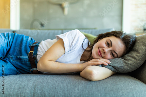 Young attractive girl sleeping on the couch in the living room