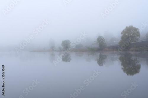 Fog on the lake, cloudy morning, poor visibility and high humidity.