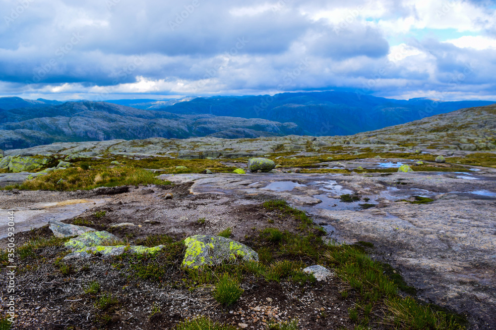 Trail to Kjeragbolten. Landscapes of the Norwegian mountains, where the famous boulder stuck at an altitude of 984 meters above Lysefjorden on Mount Kjerag, Norway