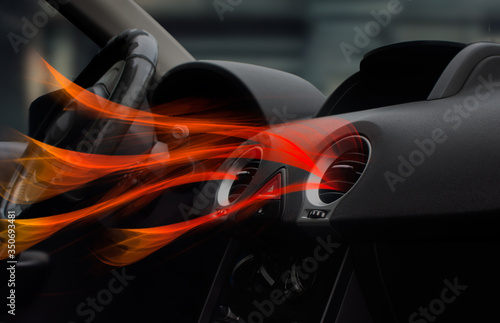 Air grids conditioning with hot air coming out. Maintenance and repair concept of the air conditioning and heating piping system. Topic of fresh air and health in the car. Automobile dashboard