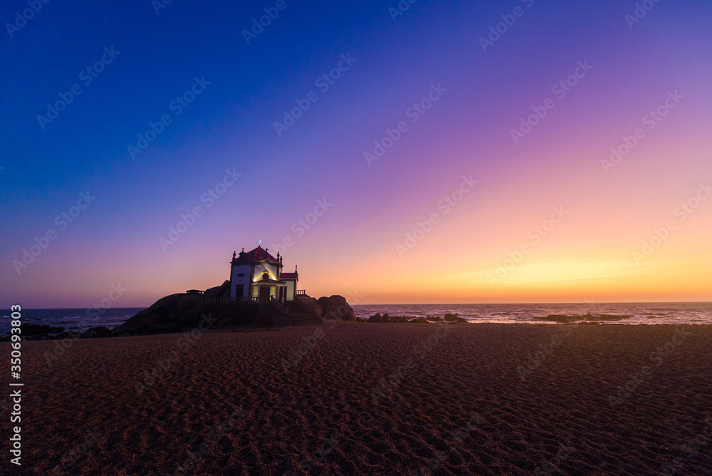 Obraz premium Tourism trip to Portugal, Porto, famous for the Capela do Senhora Pedra. Amazing cliff rocks on the Atlantic ocean west coast of Portugal in Alentejo region at sunset