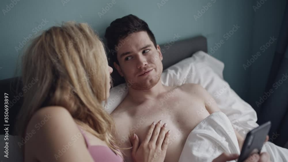 Heterosexual couple having problem in bed. Man fabbing and doesn't pay attantion to her girlfriend. Marriage, phone addiction, family, love, sex concept. Filmed on REd 4k, 10 bit color Heterosexual couple having problem in bed. Man fabbing and doesn't pay attantion to her girlfriend. Marriage, phone addiction, family, love, sex concept. Filmed on REd 4k, 10 bit color
