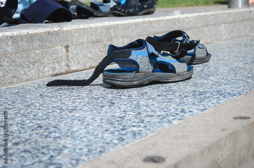 The sandals are left on the street. Begging and vagrancy