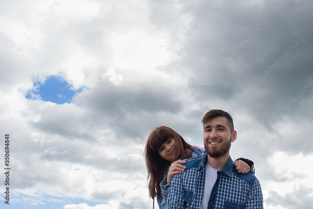 Daughter hugs her father against the sky, photo for Father's Day Daughter hugs her father against the sky, photo for Father's Day