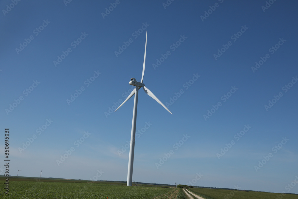 Windmill for electric power production, France. Blue sky Windmill for electric power production, France. Blue sky