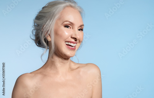 Canvas Print Happy laughing loudly senior lady with grey hair and bare shoulder portrait